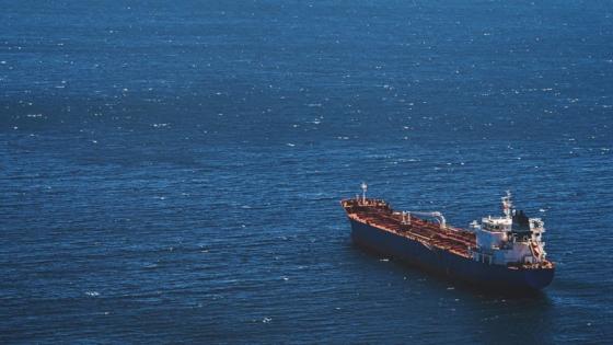 An empty cargo ship sails alone in the sea. © sergeisimonov/Shutterstock
