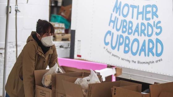 BLOOMINGTON, UNITED STATES - MARCH 24, 2020: A worker at Mother Hubbards Cupboard, a food pantry in partnership with the Hoosier Hills Foodbank, distributes food to people experiencing food insecurity, during the Covid-19-Coronavirus national emergency in Bloomington. .Amanda Nickey, President and CEO at Mother Hubbard's Cupboard, said she'd already seen more people arriving for emergency food after the mass layoffs of local workers during the COVID-19/Coronavirus emergency in Indiana.- PHOTOGRAPH BY Jeremy Hogan / Echoes Wire/ Barcroft Studios / Future Publishing (Photo credit should read Jeremy Hogan / Echoes Wire/Barcroft Media via Getty Images)
