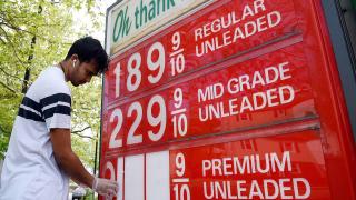 An employee of a gas station adjusts gasoline pump prices as they continue to fall with the oil market in turmoil on April 21, 2020, in Arlington, Virginia. - Collapsing demand for fuel during the COVID-19 pandemic has created a glut of oil, with storage capacity running short. President Donald Trump on Tuesday ordered his administration to come up with a plan to aid US oil companies struggling with a massive supply glut and record-low crude prices. "We will never let the great US Oil & Gas Industry down," Trump tweeted. (Photo by Olivier DOULIERY / AFP) (Photo by OLIVIER DOULIERY/AFP via Getty Images)