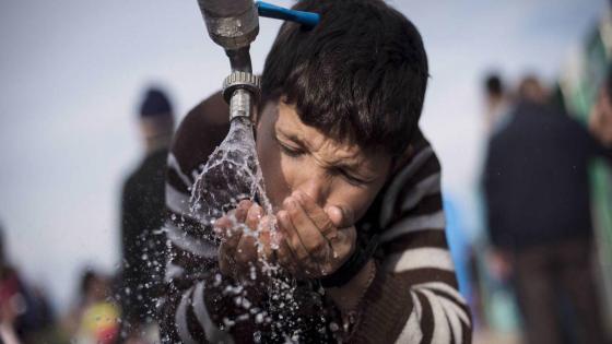 IDOMENI, GREECE - 2016/03/03: A child drinks water from a faucet while waiting a chance to cross the Greek-Macedonian border.The refugees camp on the Greek-Macedonian border in Idomeni, Macedonia is allowing only restricted entry to refugees. At the border crossing in Idomeni, a large camp with thousands of refugees has been established and new arrivals keep coming. (Photo by Michele Amoruso/Pacific Press/LightRocket via Getty Images)