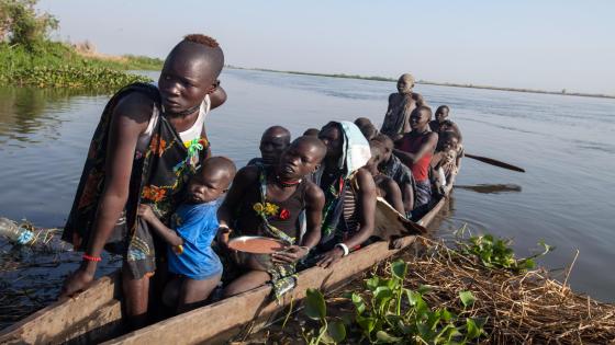 20 January 2017. Terekeka: A group of women are pictured in a boat at the side of White Nile river in Terekeka, South Sudan, where the Food and Agriculture Organisation (FAO), through its partner Set Num Fisheries Cooperative, distributes fishing kits to the community. The fishing kits enable fisherfolk to catch fish and feed their families. Each fishing kit provides enough capacity to feed 25 families for one day.
Photo by Albert Gonzalez Farran - FAO
